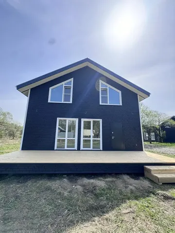 Двухэтажный каркасный дом 180 м² с тёмным фасадом и открытой террасой